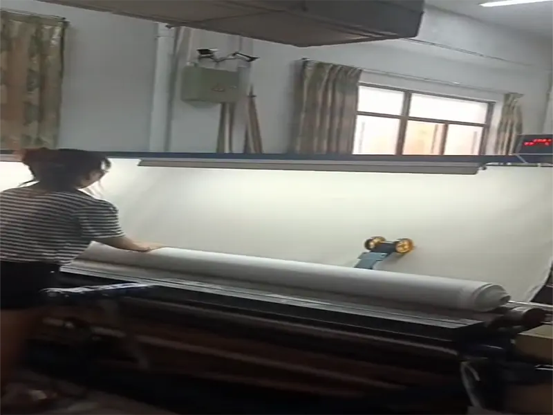 Fabric inspection and rolling process in textile factory
