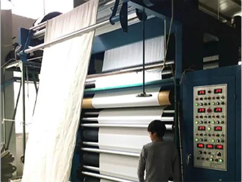 Fabric calendering machine in textile manufacturing process