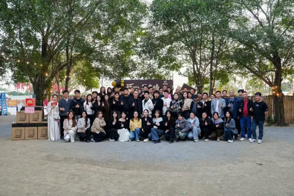Company team building group photo with event banner